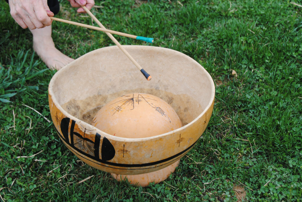 Playing water gourd drum 1024x685